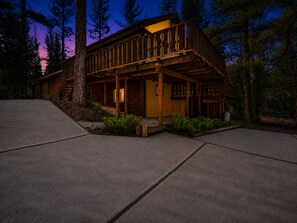 A two-story wooden cabin with a porch, surrounded by trees. - Hidden Spot (Big Bear Lake)