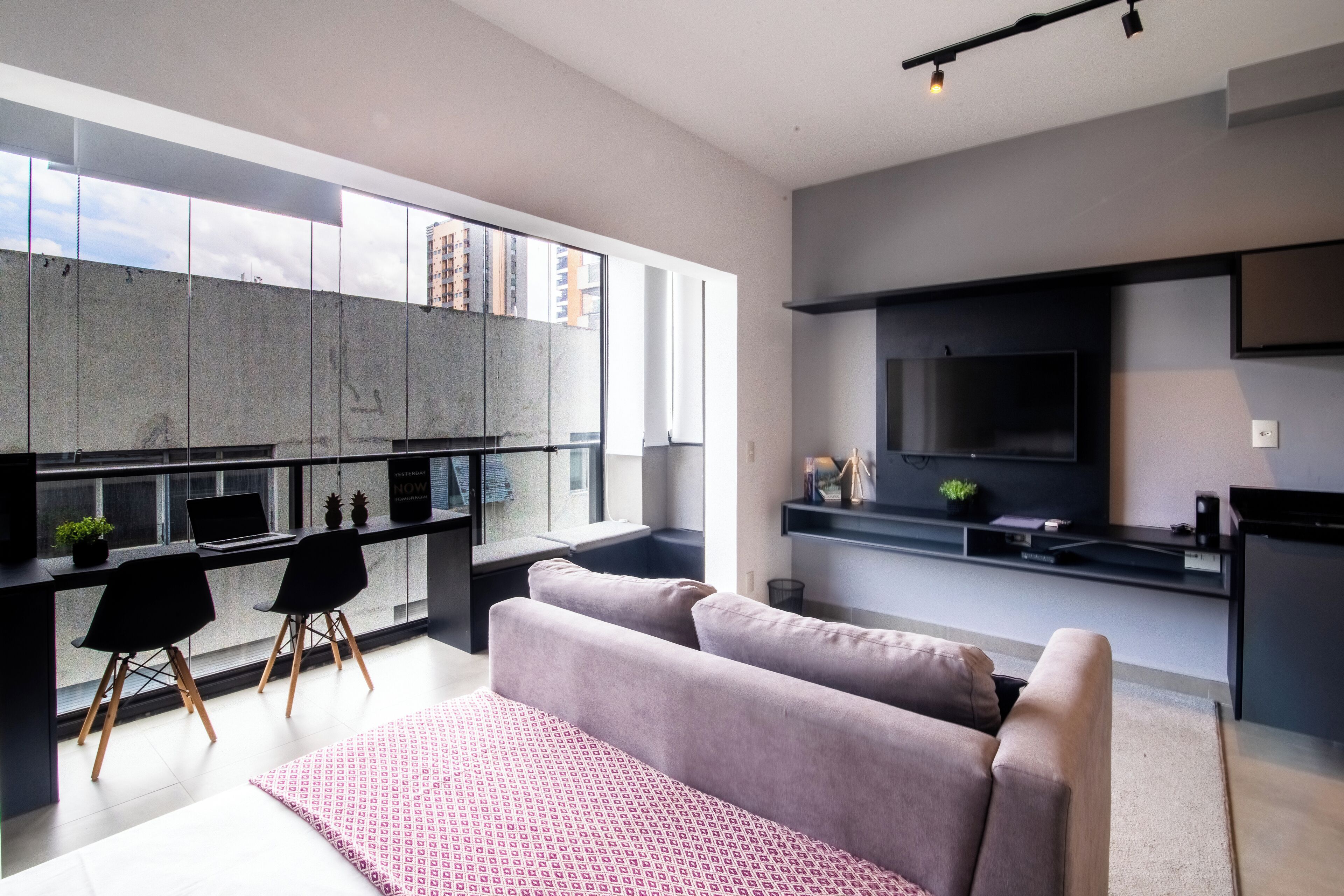 A modern apartment with a kitchen, dining area, and living room.