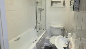 A modern bathroom with a bathtub, shower, toilet, and sink. - Terrace Lodge (Yeovil)