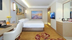 A hotel room with a bed, a desk with a laptop, a TV, and a painting on the wall. - Vienna Hotel Chengdu Dufu Cottage The Jinsha Site (Chengdu)