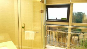 A bathroom with a glass shower enclosure, a towel rack, and a window with a view of the outside. - Vienna Hotel Chengdu Dufu Cottage The Jinsha Site (Chengdu)