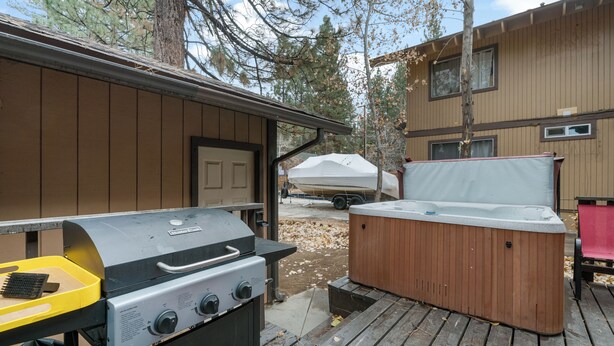 A barbecue grill and a hot tub on a wooden deck. - Bear Retreat  (Big Bear Lake)
