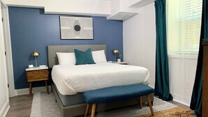 A modern bedroom with a large bed, two bedside tables, a wall art piece, and a view of the outside through a window with curtains. - FIFA World Cup - 4Mi to Stadium - Private Basement Apt - Free Parking - Kitchen (Atlanta)