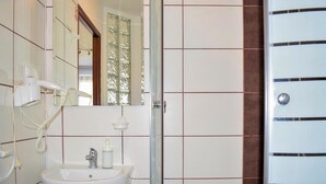 A bathroom with a sink, mirror, and hairdryer. - Awesome apartment in Ustka with WiFi (Ustka)