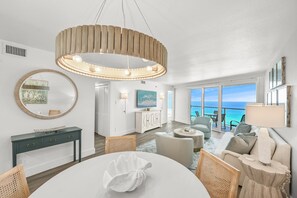Relax in this stylish living area with a sofa, dining table, and ocean view.