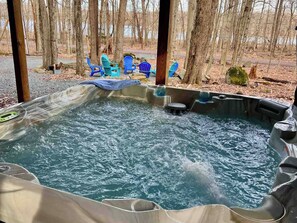 A hot tub in an outdoor setting with a forest backdrop. - Wooded Lakeside adventure, walk to dock, 4 kid kayaks, screened porch, ping pong (Pocono Lake)