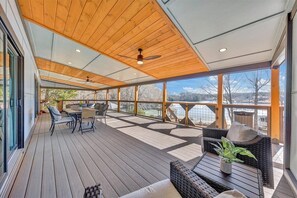Outdoor dining - 7BR/5BA SML Lakefront – Walk to Private Dock w/ Boat Lifts, Fire Pit & Views! (Wirtz)