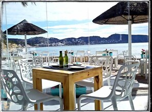 Enjoy al fresco dining with a view of the sea and distant mountains.