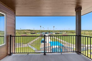 A covered balcony with a view of a sports field and buildings. - Holiday Inn Express Kansas City North Parkville (Parkville)