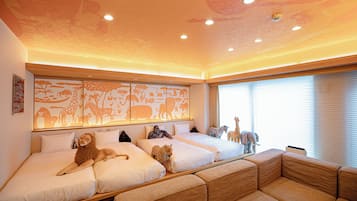 A hotel room with two beds, a large mural of animals on the wall, and a window with blinds.
