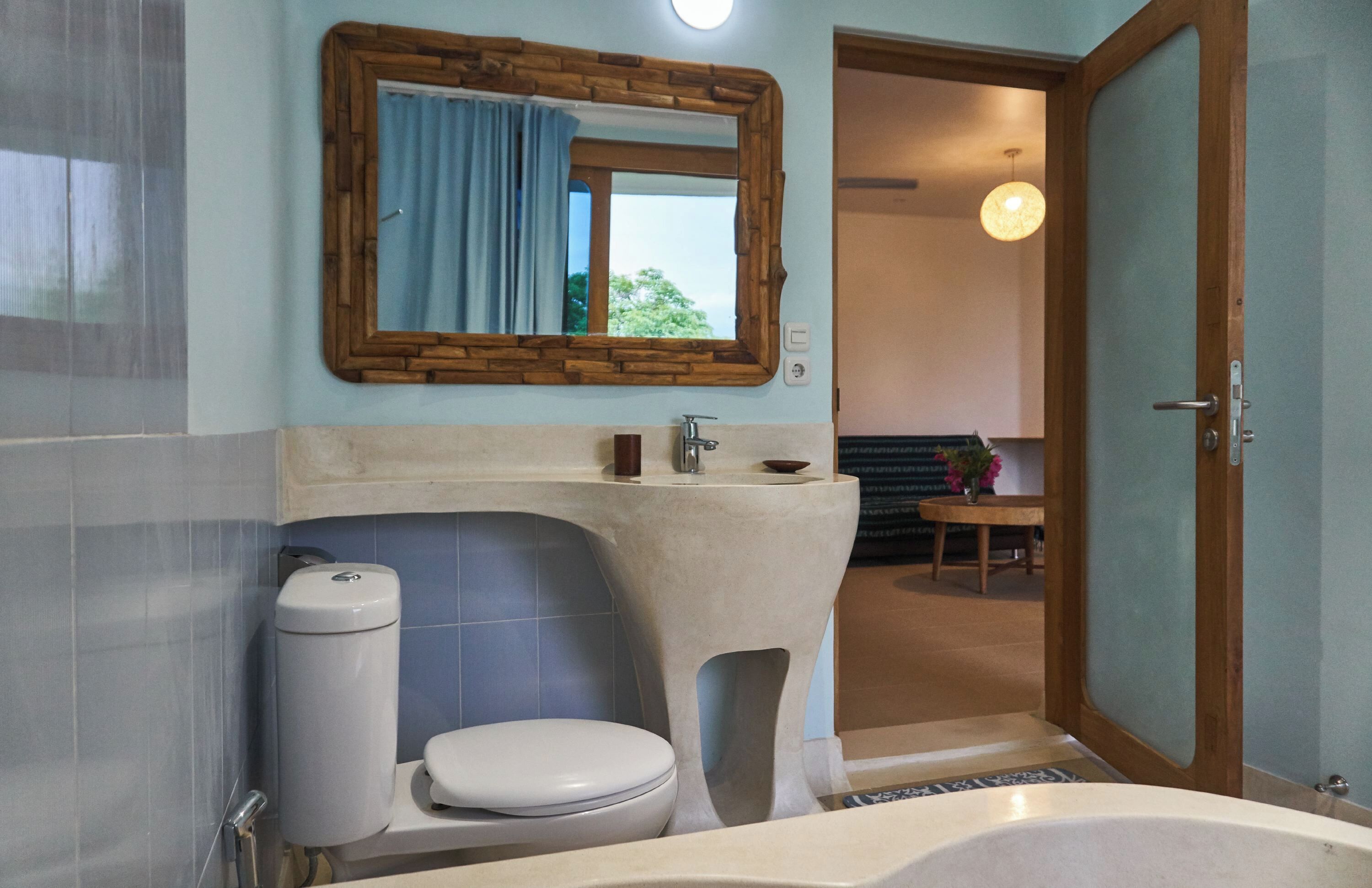 A bathroom with a toilet, sink, and bathtub.