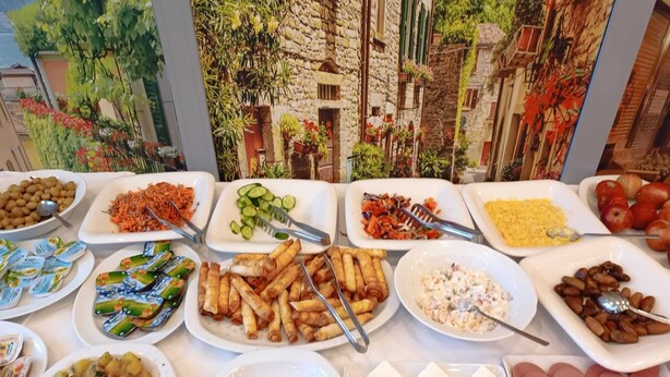 A buffet with various dishes including salads, fruits, and appetizers. - Bona Sera Hotel (Istanbul)