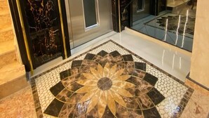 An elevator with a digital display, a metallic door, and a patterned floor. - Bona Sera Hotel (Istanbul)
