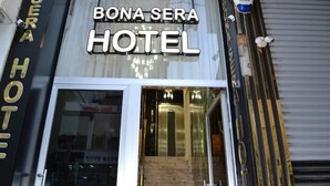 The exterior of the Bona Sera Hotel with a glass entrance and a visible staircase leading to the lobby. - Bona Sera Hotel (Istanbul)