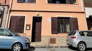 A two-story building with a balcony, a door, and a window with shutters. - Cirismiro Torre Faro B&B  (Torre Faro)