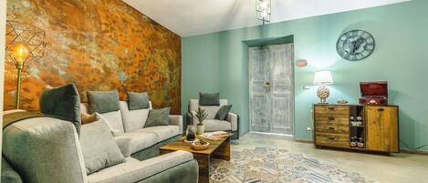 A living room with a sofa, coffee table, and a patterned rug.
