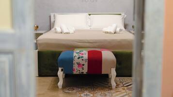 A neatly made bed with two pillows and two folded towels.