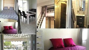 A hotel room with a bed, a desk, a chair, a staircase, and a bathroom.