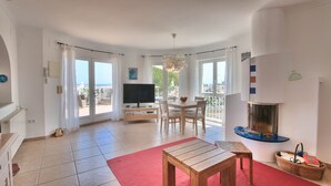 A spacious living room with a dining area, a television, and a fireplace. - Villa with panoramic views all inclusive in Denia (Denia)