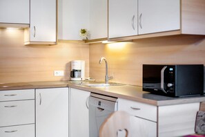 Fridge, stovetop, dishwasher, coffee/tea maker