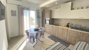 Uma cozinha moderna com área de jantar, forno embutido e fogão a gás.