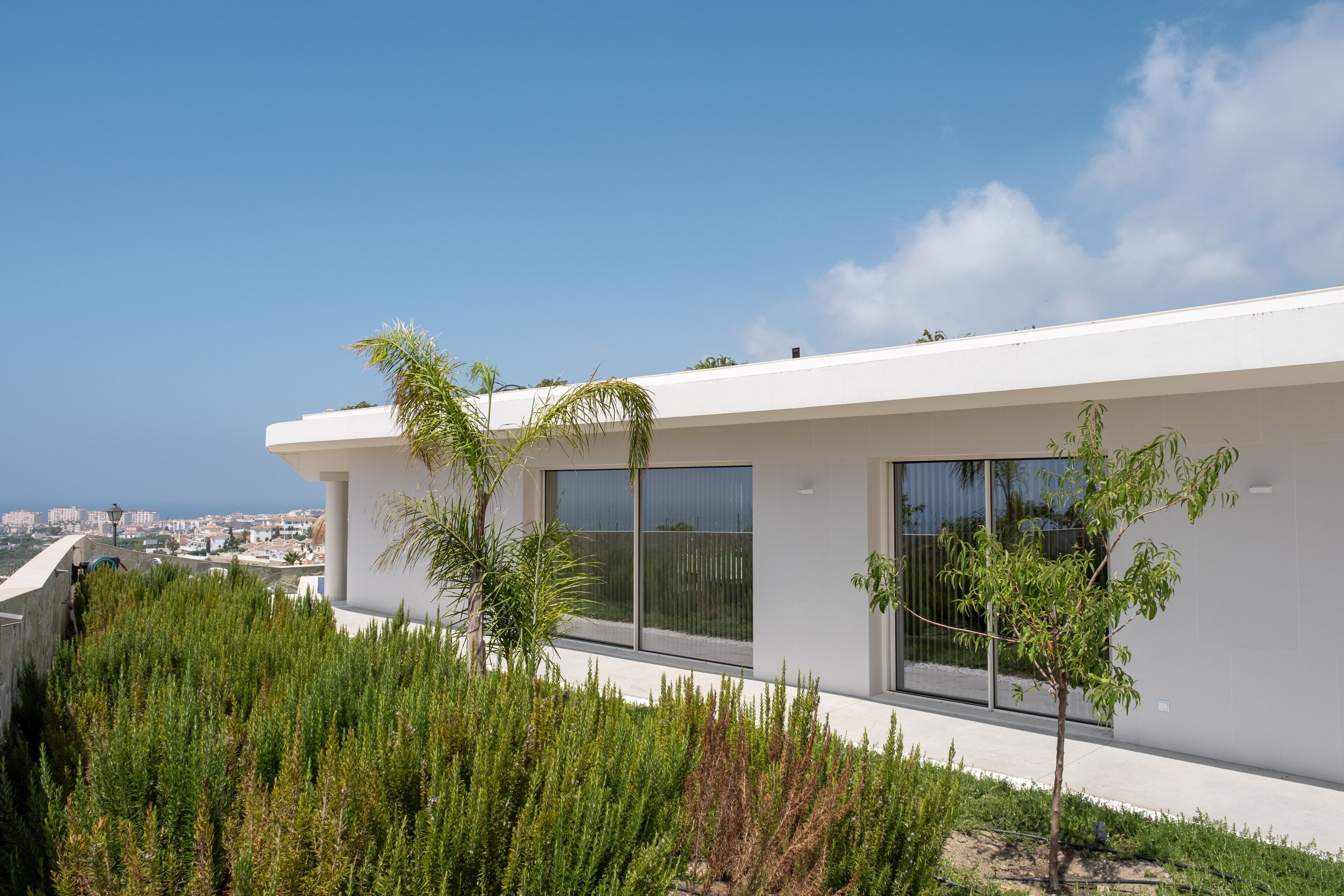 A modern building with large windows and a view of the city.