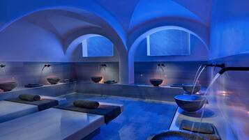Experience serenity in our spa area, featuring arched alcoves and a water feature.