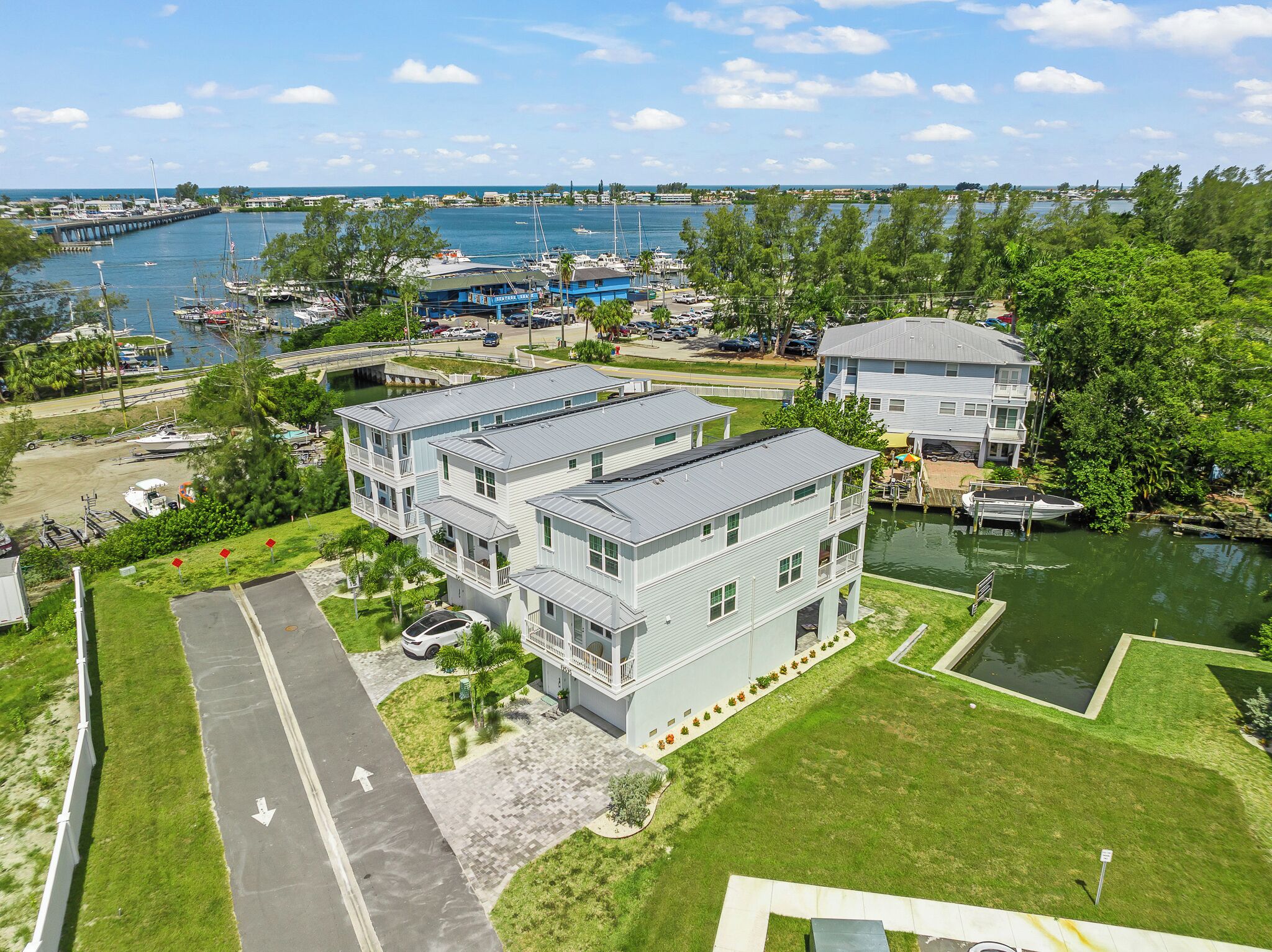 A waterfront property with a marina, a bridge, and a large building with multiple balconies.