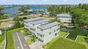 A waterfront property with a marina, a bridge, and a large building with multiple balconies.