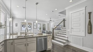 A modern kitchen with a central island, stainless steel appliances, and pendant lighting. - ☀️Highland Parks 30A-Pool-Bikes-Barefoot Blessing (Santa Rosa Beach)