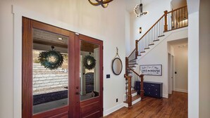 A wooden staircase with a sign reading "Turtle Cove College Lake House" leading to an upper floor.