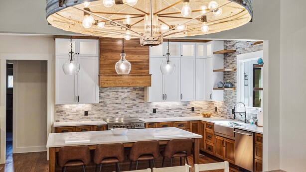 A modern kitchen with a central island, wooden cabinets, and a hanging light fixture labeled "LAKE".