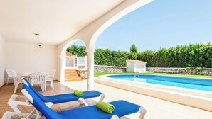 A poolside area with lounge chairs and a view of a swimming pool. - Binifortu - Four Bedroom Villa, Sleeps 8 (Punta Prima)