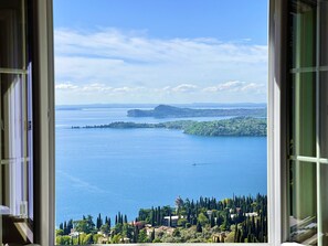 Enjoy breathtaking views of a tranquil body of water from this serene room.