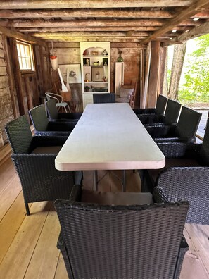 A rustic wooden room with a long table and wicker chairs. - Family, friends, Gathering (Standish)