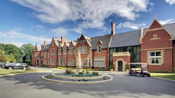 A large, historic building with a central courtyard, a statue, and a well-maintained lawn. - 2 Railway Terrace (Hurworth Place)