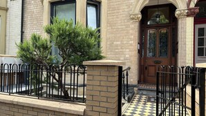 A building with a brick facade, large windows, and a black and white checkered entrance. - Central Studios (Cardiff)