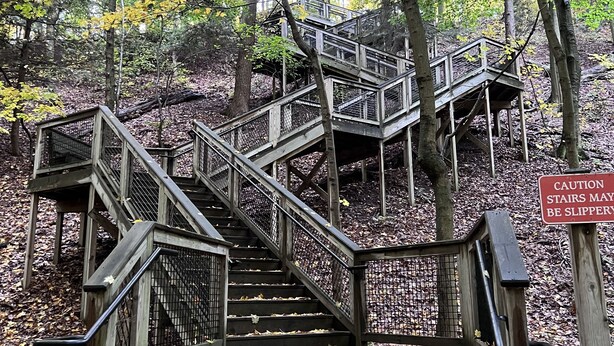 A wooden staircase with a caution sign warning that stairs may be slippery. - Hot tub, Nature, Parks and Beaches! Right in between Holland and Grand Haven. (West Olive)