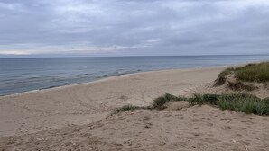 A beach with a sandy shore and grassy dunes. - Hot tub, Nature, Parks and Beaches! Right in between Holland and Grand Haven. (West Olive)