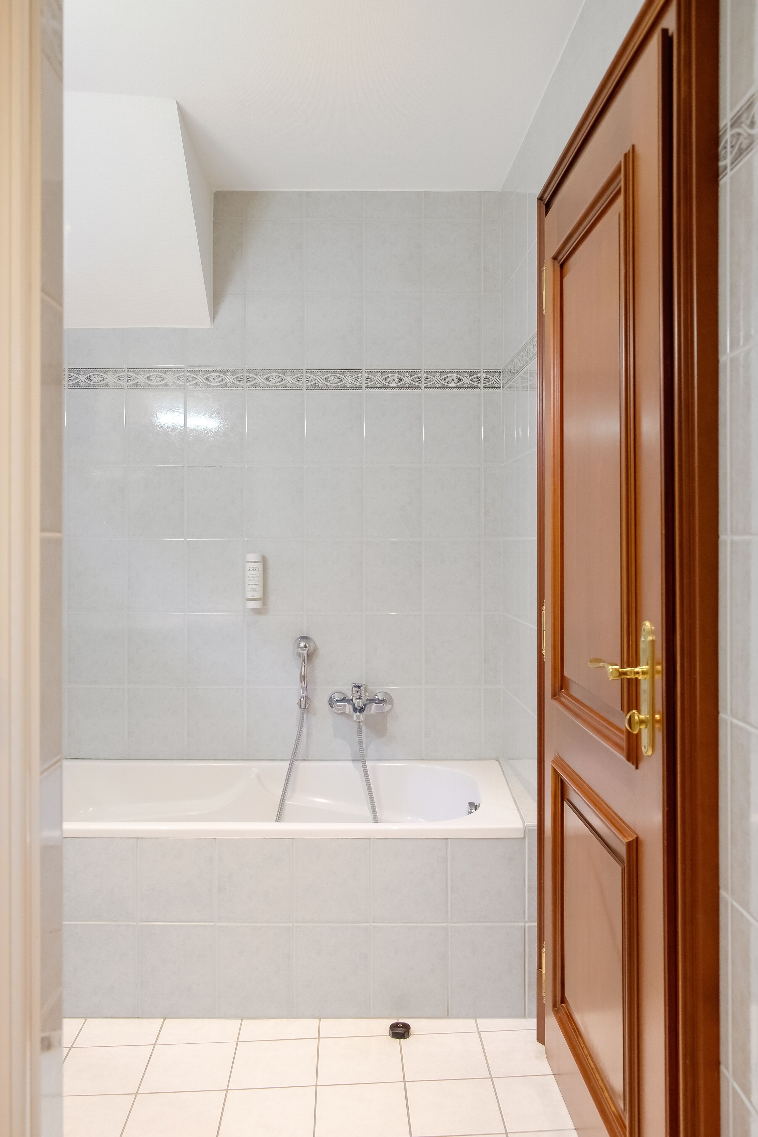 A bathroom with a bathtub, a shower, and a toilet.