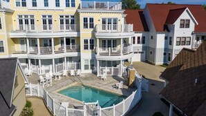 A multi-story building with balconies and a swimming pool.