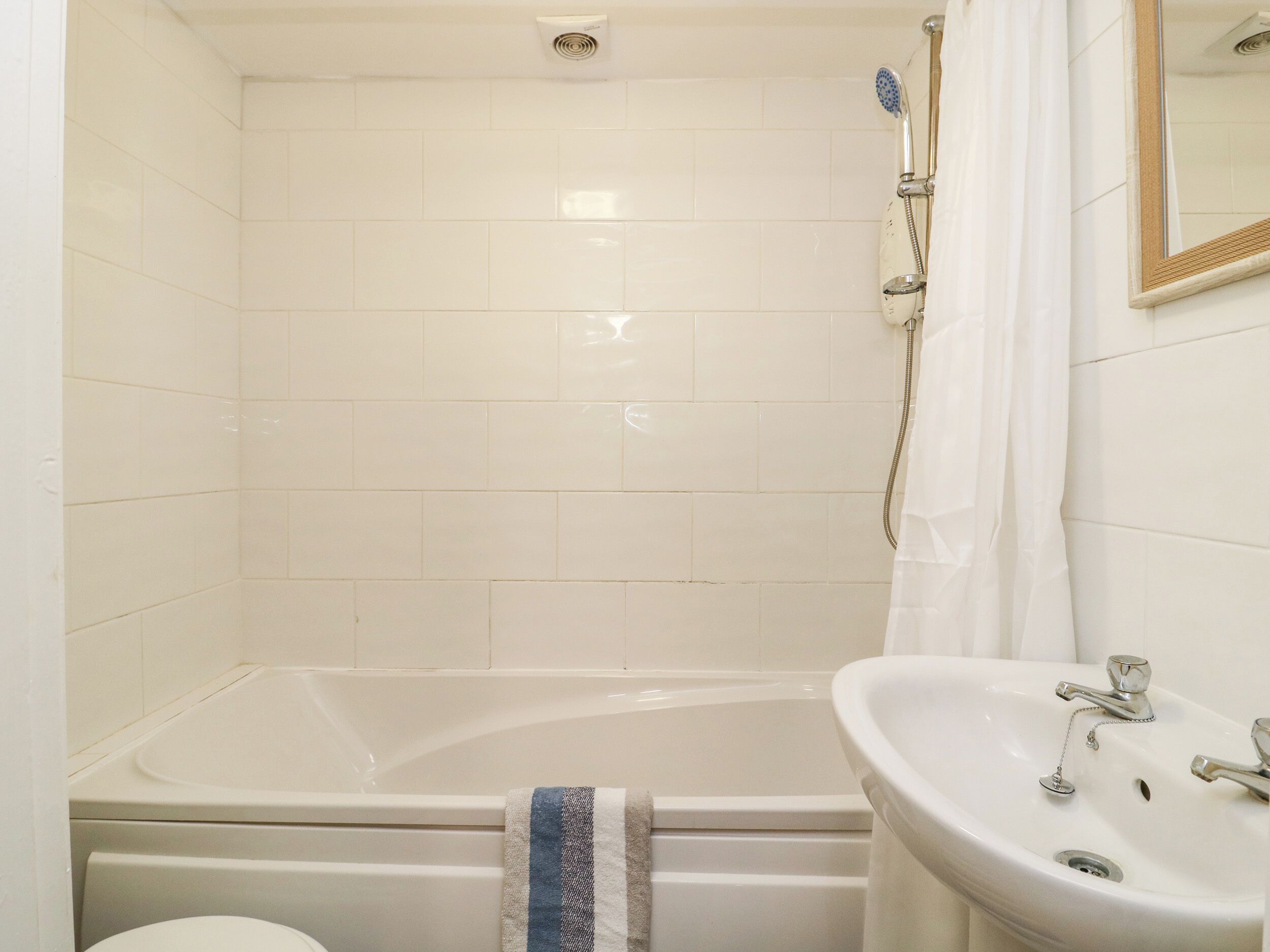 A bathroom with a bathtub, a sink, and a shower.