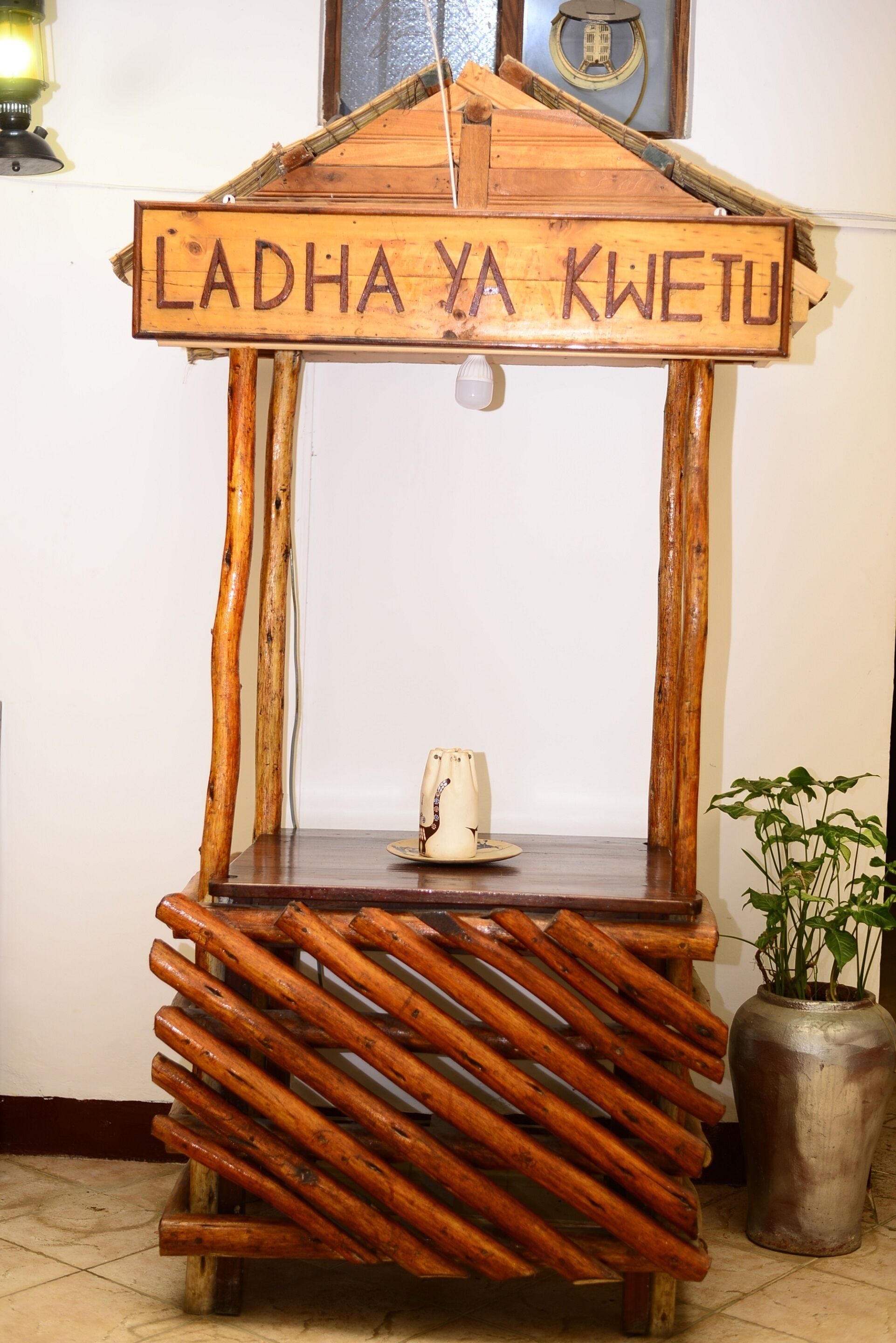 A wooden structure with a sign that reads "LADHA YA KWETU".