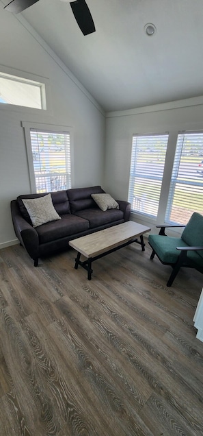 Deluxe Cottage | Living area | Flat-screen TV - Oceans RV Resort (Holly Ridge)