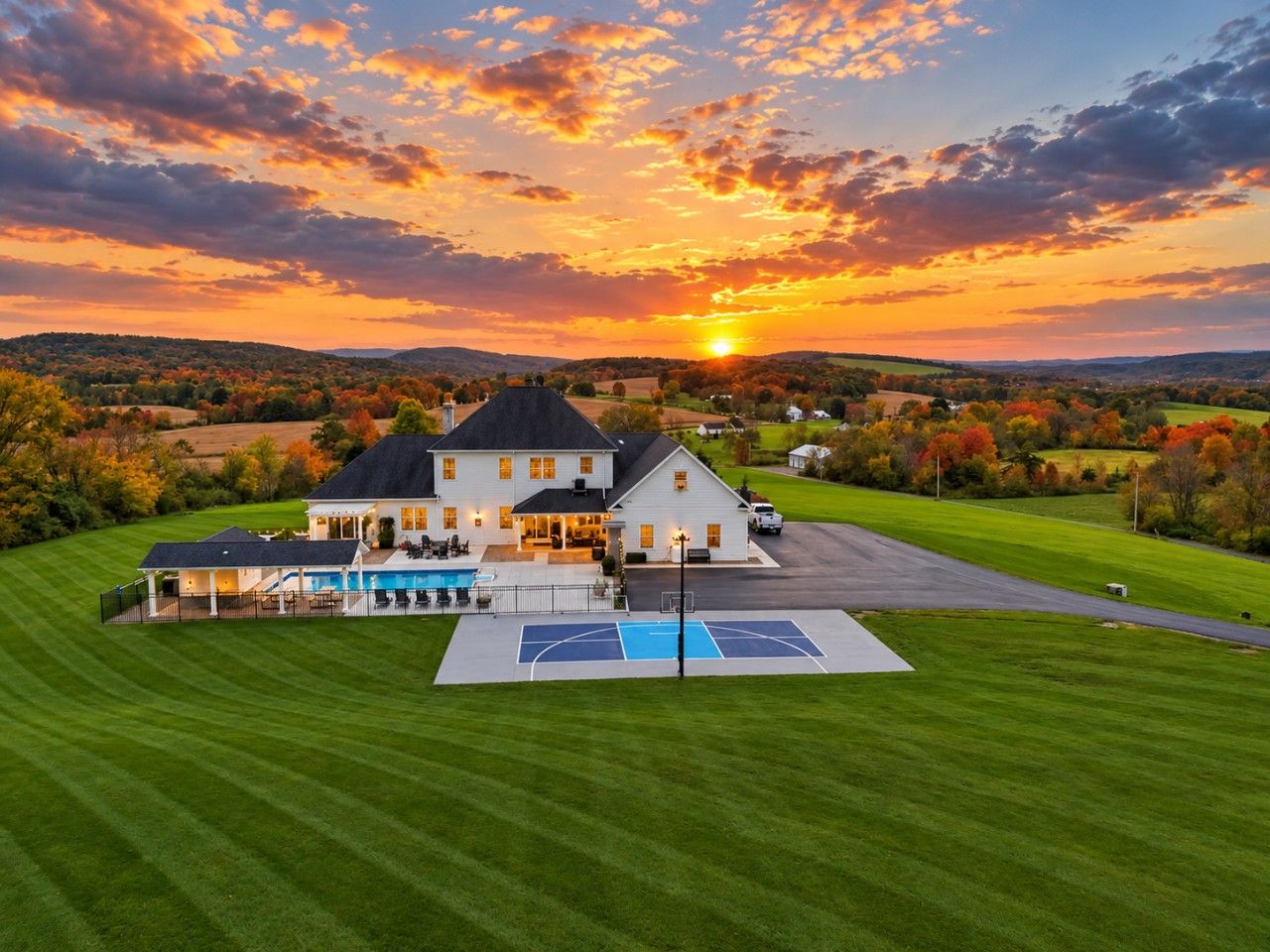 A large house with a swimming pool and a basketball court.