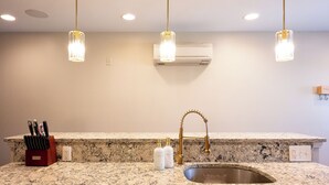 A kitchen with granite countertops, a gold faucet, and pendant lights. - Spacious Fed Hill Home w/Rooftop & 4 Parking Spots (Baltimore)