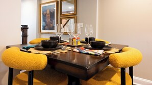 A dining table set with clear glasses, black bowls, and a canister. - Spacious Fed Hill Home w/Rooftop & 4 Parking Spots (Baltimore)