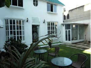 Guests can enjoy a patio with a table and chairs.