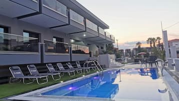 Seasonal outdoor pool, open 10:00 AM to 7:30 PM, pool umbrellas