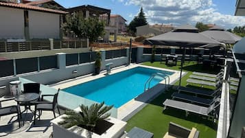 Seasonal outdoor pool, open 10:00 AM to 7:30 PM, pool umbrellas